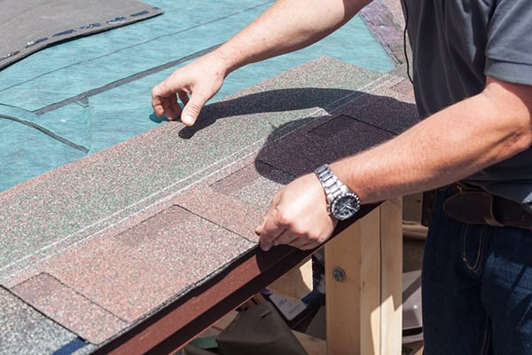 image of roofing contractor installing composition roof shingles