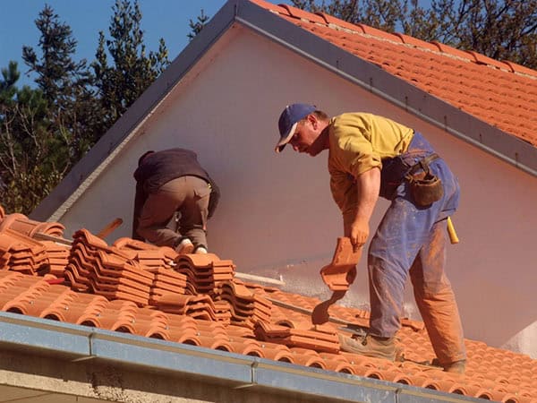 roofing contractor repairing tile roof